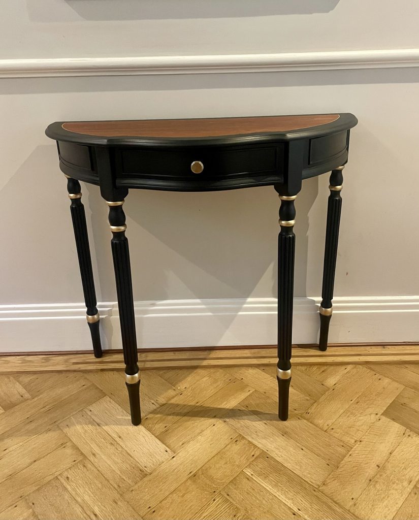 The Demi-Lune Console against a panelled wall on herringbone parquet