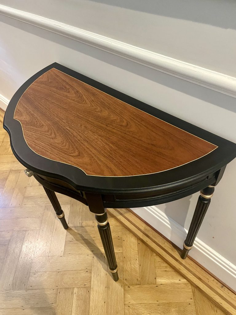 Angled view of the demi-lune top and its original inlaid border