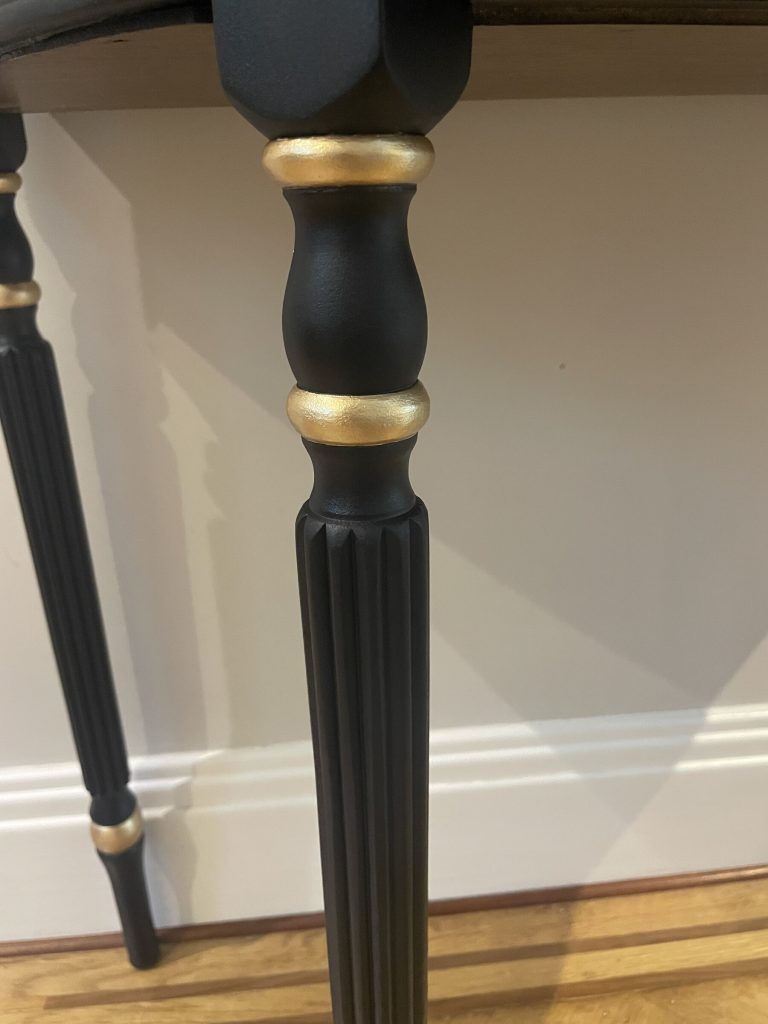 Hand-painted gold band on a fluted leg of the Demi-Lune Console